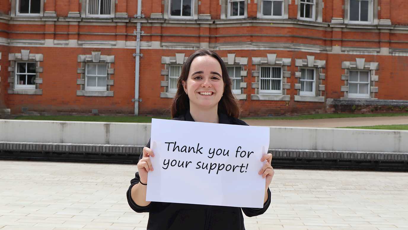Student with Thank you placard.jpg