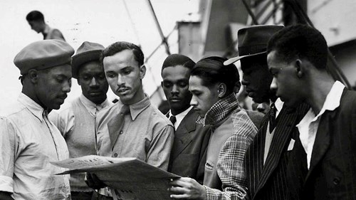 Group of black men read a newspaper