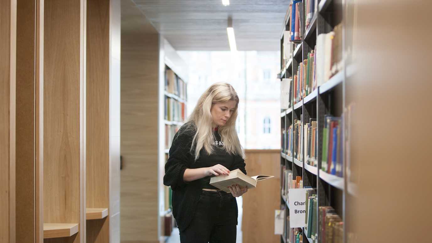 Student in the library searching archives