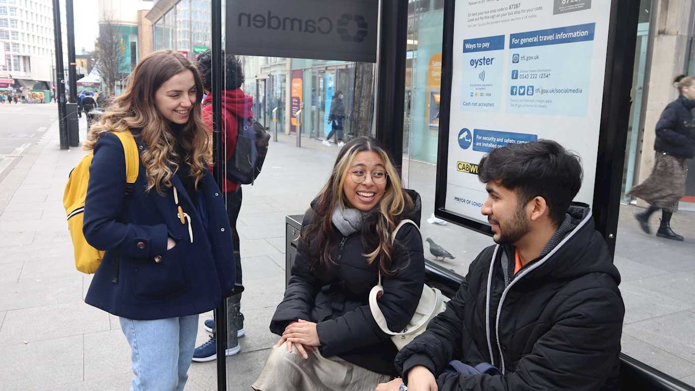 Students at bus stop in Tottenham Court Road: 
