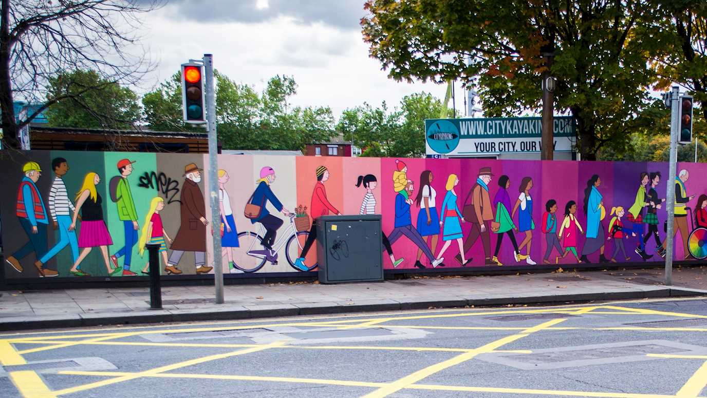 Colourful wall art of diverse people walking together.