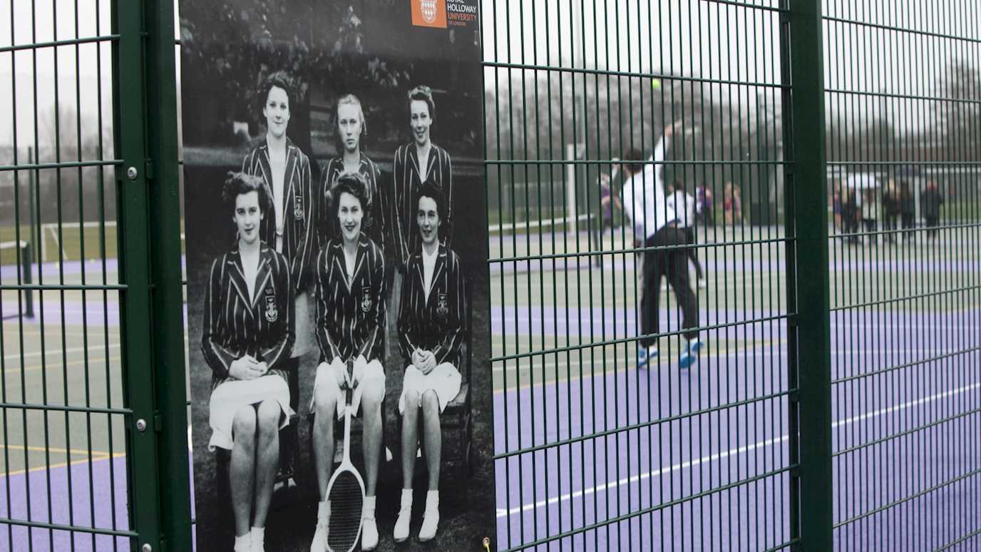 a shot of the tennis courts with a poster of a historic tennis squad on the fence - about us