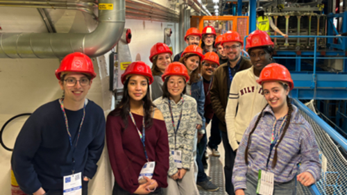 Group photo of students wearing hard hats in CERN's underground facilities