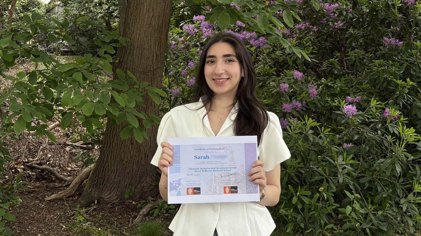 Sarah holding a Royal Holloway Business School certificate during her final year 